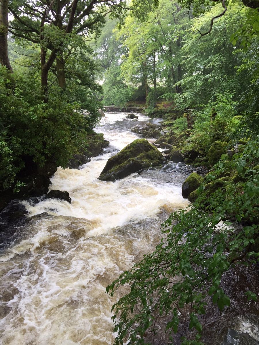 Beddgelert in summer with green hills and blue sky