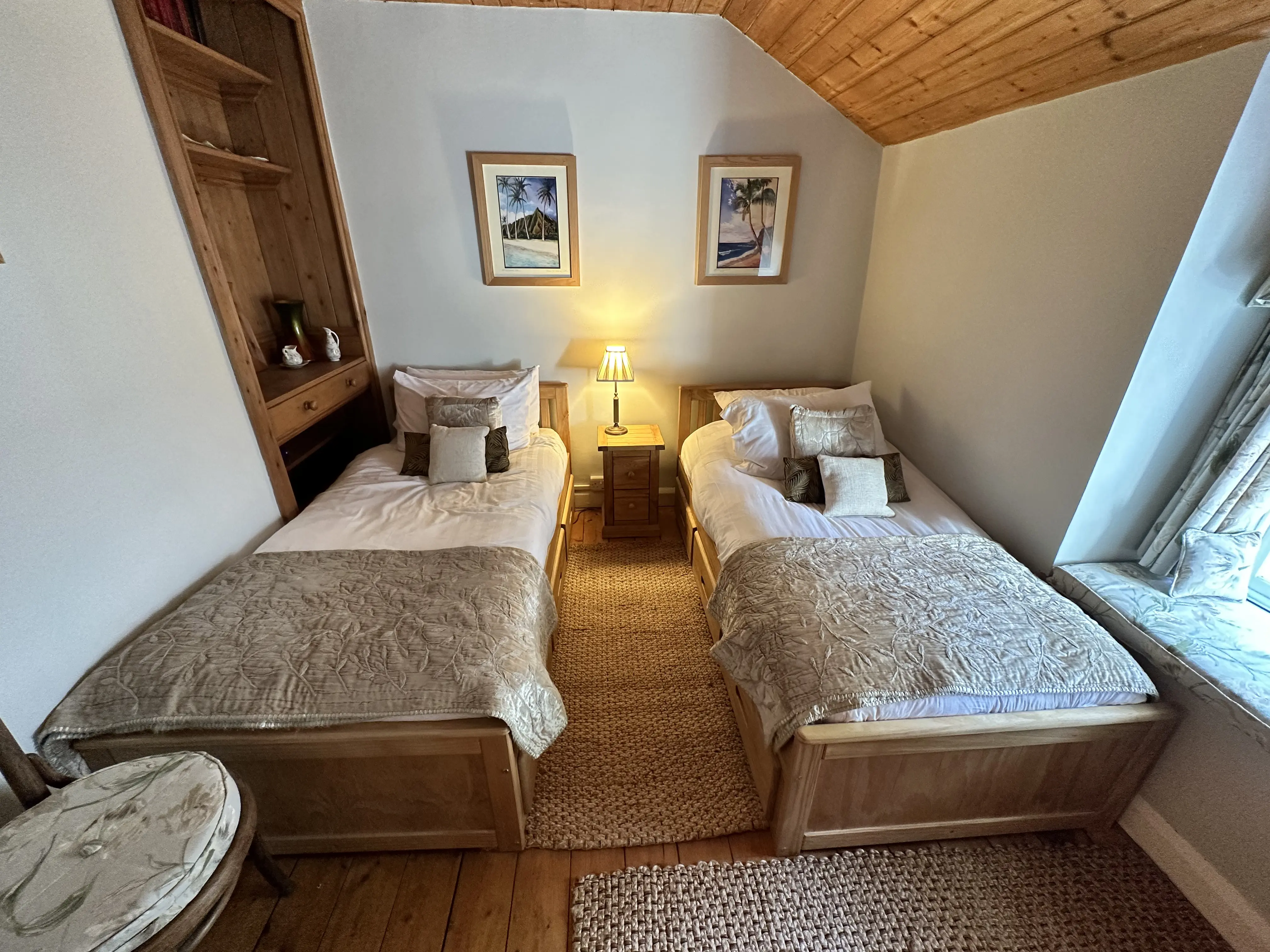 Twin bedroom with pine beds and wooden ceiling